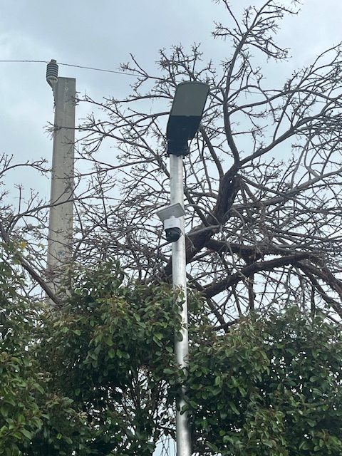 Security camera mounted on pole overlooking the lot